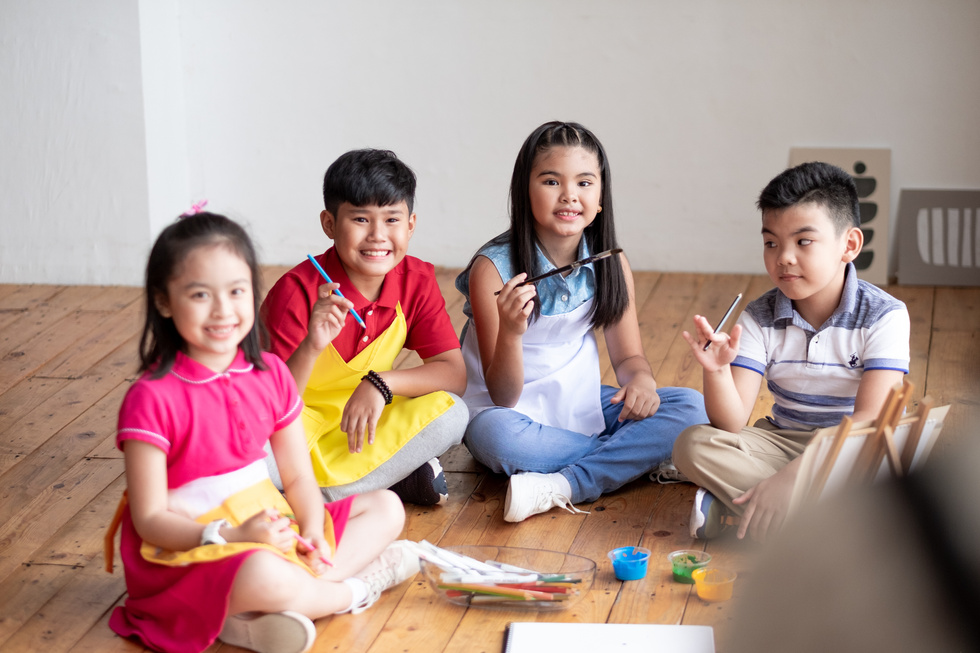 Children with Paintbrushes and Paints in Art Class